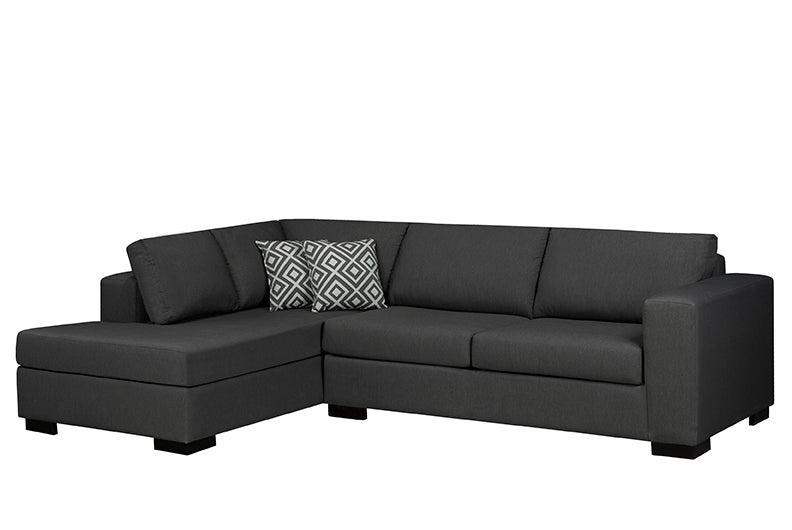 Black sectional sofa with a patterned pillow on a white background