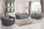 Gray tufted sofa set in a stylish living room with large windows.