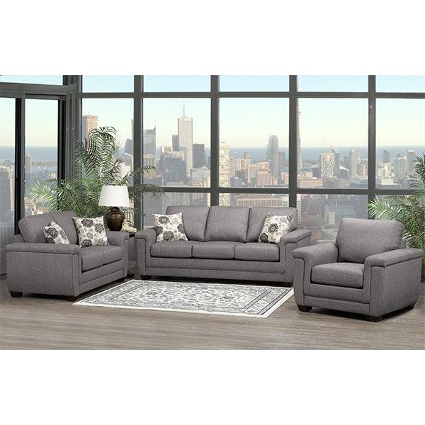 Gray sectional sofa in a living room with large windows showing a cityscape.