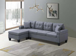 Gray sectional sofa in a living room with a window and wall art.