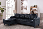 Black leather sectional sofa in a living room setting with decor elements.