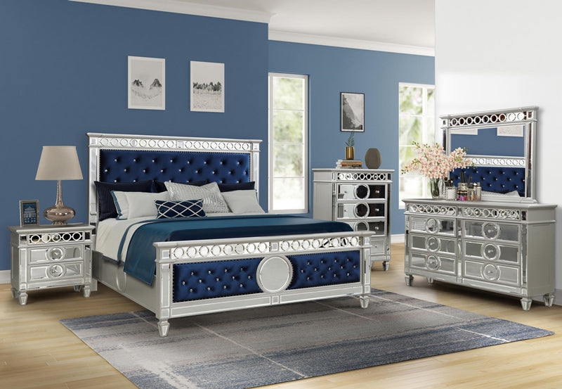 Luxury bedroom set with blue and silver furniture in a room with blue walls.